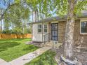 Charming brick home featuring a well-manicured lawn and mature tree at 1720 S Ammons St # A, Lakewood, CO 80232