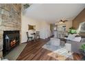 Cozy living room features a stone fireplace and seamlessly connects to the adjacent kitchen area at 1731 S Blackhawk Way # A, Aurora, CO 80012