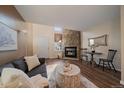 Inviting living area with stone fireplace, wood flooring, and a light, airy atmosphere at 1731 S Blackhawk Way # A, Aurora, CO 80012