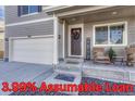 Charming home with a two-car garage, inviting front porch, and a beautifully decorated front door at 2262 Monte Vista St, Fort Lupton, CO 80621