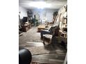 Comfortable living room featuring carpet and wood flooring, a neutral color scheme, and rustic furniture pieces at 9115 W 2Nd Ave, Lakewood, CO 80226