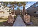 Attractive building entrance with stone pillars and landscaping at 936 Eudora St # 102, Denver, CO 80220