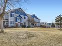 Blue and gray townhome showcasing a large lawn at 12941 Lafayette St # E, Thornton, CO 80241