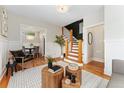 Stylish living room with hardwood floors, a cozy seating area, and a view into the dining area at 187 S Pearl St, Denver, CO 80209