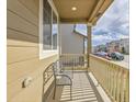 Inviting front porch with a cozy bench and wood railing to relax and enjoy the neighborhood at 9844 Truckee St, Commerce City, CO 80022