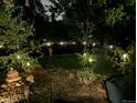 This backyard provides tranquility with the landscape lighting, trees and shrubbery at 7344 S Sheephorn Mtn, Littleton, CO 80127