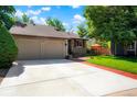 Traditional home with a large driveway and attached two-car garage offers ample parking at 7344 S Sheephorn Mtn, Littleton, CO 80127