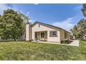 Single-story home with a well-maintained lawn, showcasing its simple architectural design and cream siding at 7830 W 90Th Ave # 67, Broomfield, CO 80021