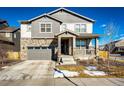 Two-story house with gray siding, stone accents, and a two-car garage at 24505 E Ada Pl, Aurora, CO 80018