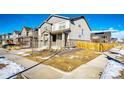 Two-story house with gray siding, stone accents, and a two-car garage at 24505 E Ada Pl, Aurora, CO 80018