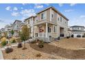 Exterior view of a two-story home with stone accents and well-maintained landscaping at 1635 S Andes Way, Aurora, CO 80017