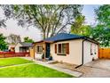 Charming home with a well-manicured lawn, fresh landscaping, and a charming pergola covered entry at 150 S Osceola St, Denver, CO 80219