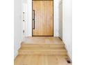 View of foyer featuring a light wood door and flooring, with white walls and modern staircase at 2190 Vine Ave, Boulder, CO 80304