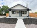 Inviting exterior elevation showcasing the home's modern curb appeal and manicured front yard landscaping at 1694 Xanthia St, Denver, CO 80220