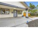 Inviting front porch of this well-kept home features a painted porch and a secure ADT security sign at 1694 Xanthia St, Denver, CO 80220