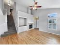 Bright living room with vaulted ceilings, fireplace, and hardwood floors at 10674 Cherrington St, Highlands Ranch, CO 80126