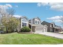 Well-maintained two-story home with a spacious front yard and a three-car attached garage at 11035 W Grand Pl, Littleton, CO 80127