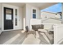 Covered front porch with seating area, creating a welcoming entryway at 1171 E Hopkins Dr, Elizabeth, CO 80107