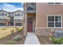 Close up view of the front entrance with manicured landscape and decorative wreath at 2225 Santini Trl # A, Littleton, CO 80129