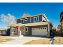 Two-story craftsman style home with gray siding, stone accents and a red door at 3050 S Ash St, Denver, CO 80222