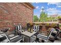 Outdoor patio featuring brick walls, comfortable seating, and decorative flower boxes for relaxing and entertaining at 2587 S Harlan Ct, Lakewood, CO 80227