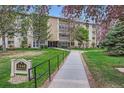 Well-manicured condo building with lawn and garden, featuring flowering trees in season at 3144 S Wheeling Way # 401, Aurora, CO 80014