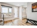 Bright foyer with wood floors, modern staircase, and built-in bench offers a welcoming entrance at 3550 Uinta St # 6, Denver, CO 80238