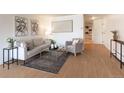 Comfortable living room with neutral tones, modern decor, and wood-style flooring at 1090 N Lafayette St # 305, Denver, CO 80218