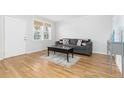 Living room with hardwood floors, gray couch, and a coffee table at 3428 S Sherman St, Englewood, CO 80113