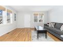 Living room features hardwood floors, gray couch, and coffee table at 3428 S Sherman St, Englewood, CO 80113