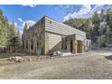 Well-maintained home exterior with stone accents and a gravel driveway at 2971 Fall River Rd, Idaho Springs, CO 80452