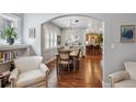 Spacious dining room with an arched doorway, hardwood floors, and modern lighting fixtures at 583 S York St, Denver, CO 80209