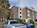 Exterior of an apartment complex with dedicated visitor parking, and a natural green space at 384 S Ironton St # 407, Aurora, CO 80012