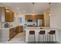Modern kitchen featuring stainless steel appliances, granite countertops, and a breakfast bar with seating at 862 W 129Th Pl, Westminster, CO 80234