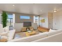 Cozy living room with large windows, comfortable seating, and a media center for entertainment at 862 W 129Th Pl, Westminster, CO 80234