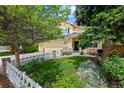 Lovely two-story home with a lush front yard, mature trees, a three car garage, and inviting curb appeal at 7638 S Hudson Way, Centennial, CO 80122