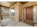 Welcoming front porch featuring stone accents, an elegant door, and decorative stained glass at 2647 Gray Wolf Loop, Broomfield, CO 80023