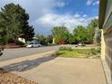 Street view of the neighborhood with mature trees and well-maintained lawns at 9852 W 76Th Ave, Arvada, CO 80005