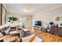 Living room features hardwood floors, large TV, and comfy seating at 4444 Irving St, Denver, CO 80211