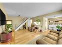 Bright living room features hardwood floors, and a staircase leading to the upper level at 6650 E Arizona Ave # 163, Denver, CO 80224