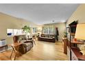 Open-concept living area with hardwood floors, comfortable seating, and plenty of natural light at 6650 E Arizona Ave # 163, Denver, CO 80224