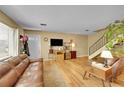 Cozy living room with hardwood floors, a modern TV, and a welcoming front door at 6650 E Arizona Ave # 163, Denver, CO 80224