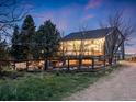 Exterior view of the rear of the home showcasing the wooden deck, outdoor space, and surrounding greenery at 1559 Lisbon Dr, Parker, CO 80138