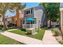 View of the townhome with a brick chimney and outdoor electrical utility box at 709 S Depew St, Lakewood, CO 80226