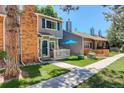 Exterior showcasing well-maintained townhomes with brick accents and landscaped front yards at 709 S Depew St, Lakewood, CO 80226