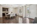 Elegant dining room features modern light fixture, dark hardwood floors, and bright window at 19471 W 59Th Ave, Golden, CO 80403