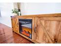 A rustic wooden entertainment center complete with an electric fireplace at 10669 Worchester Dr, Commerce City, CO 80022
