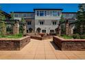 A well-maintained building exterior with a central courtyard and stone planters, showing a tranquil setting at 2800 Aurora Ave # 121, Boulder, CO 80303