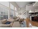 Open-concept living room with vaulted ceilings, hardwood floors, and easy access to the kitchen at 6848 Zenobia St # 9, Westminster, CO 80030