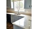 Kitchen sink with stainless steel appliances, modern finishes, and a window view at 5151 Jasper St, Denver, CO 80239